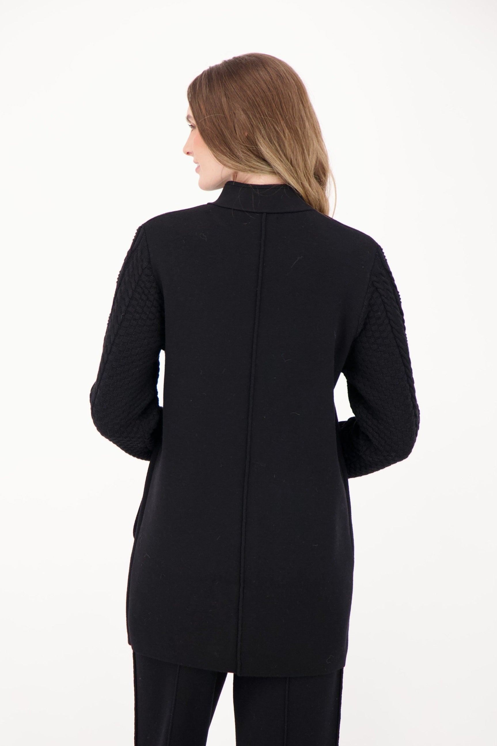 Woman wearing a black coat on a white background