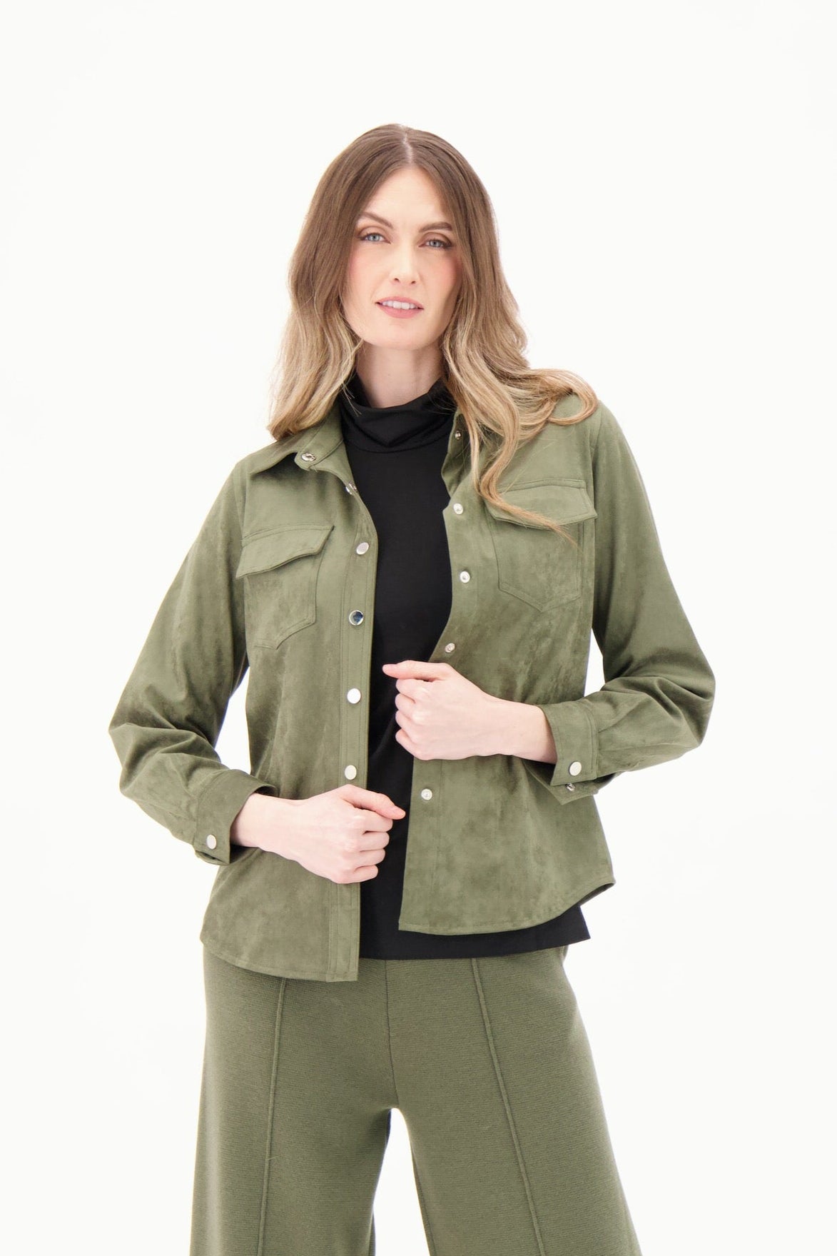Woman wearing an olive green jacket and pants on a white background