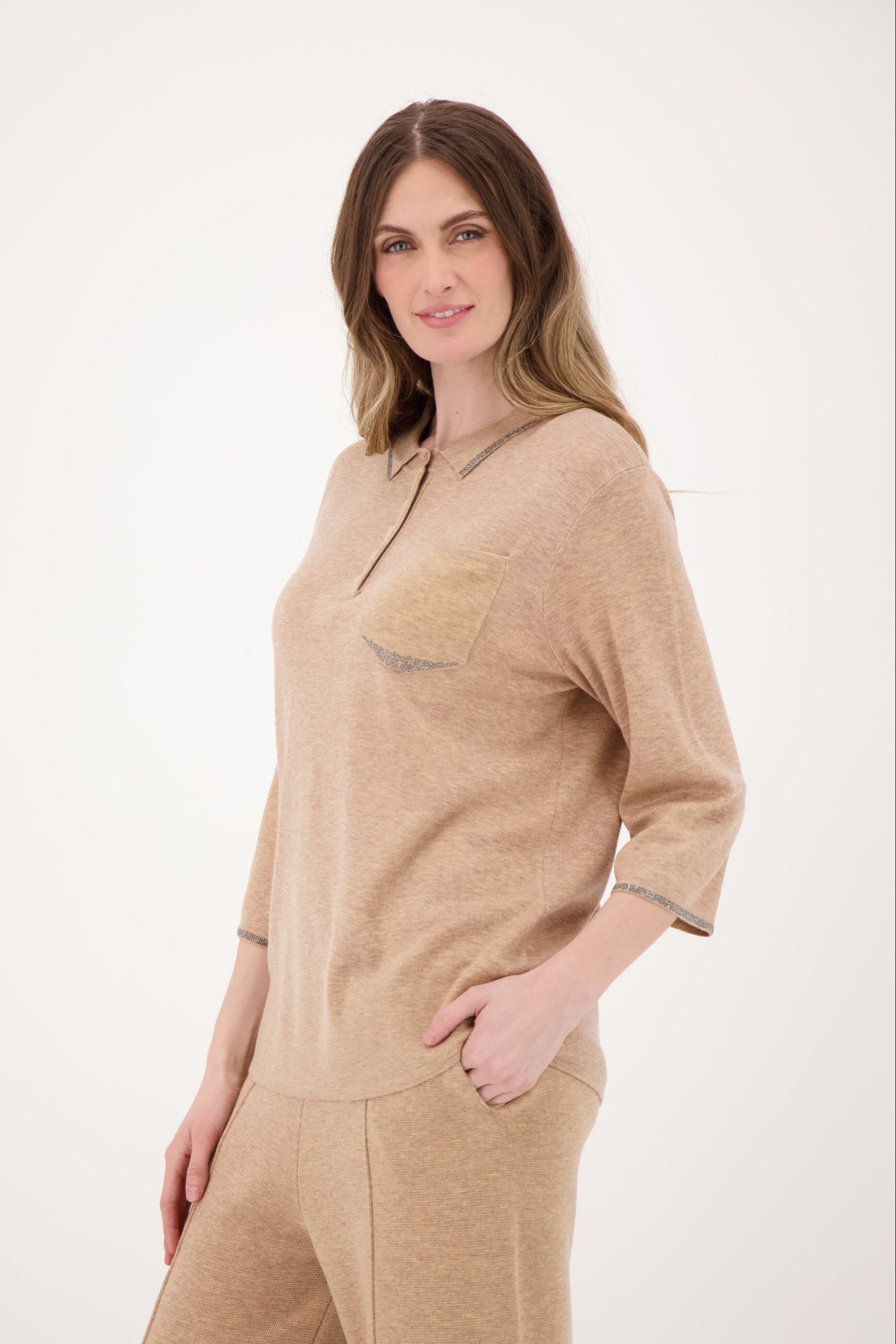 Woman wearing a beige loungewear set on a white background