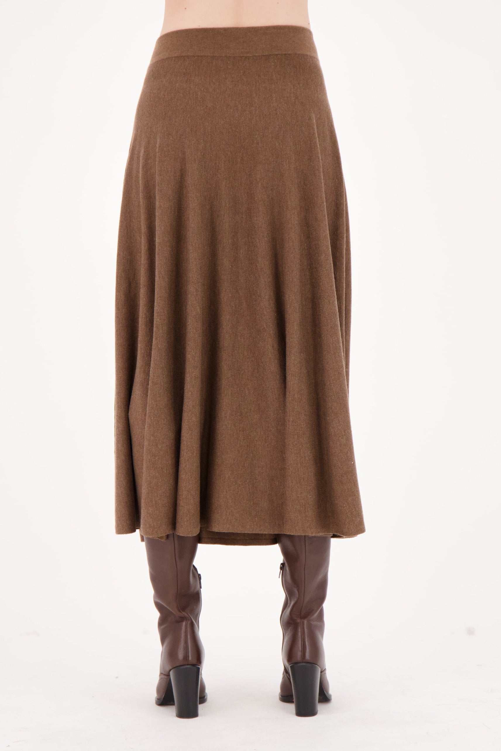 Brown skirt worn by a person on a white background