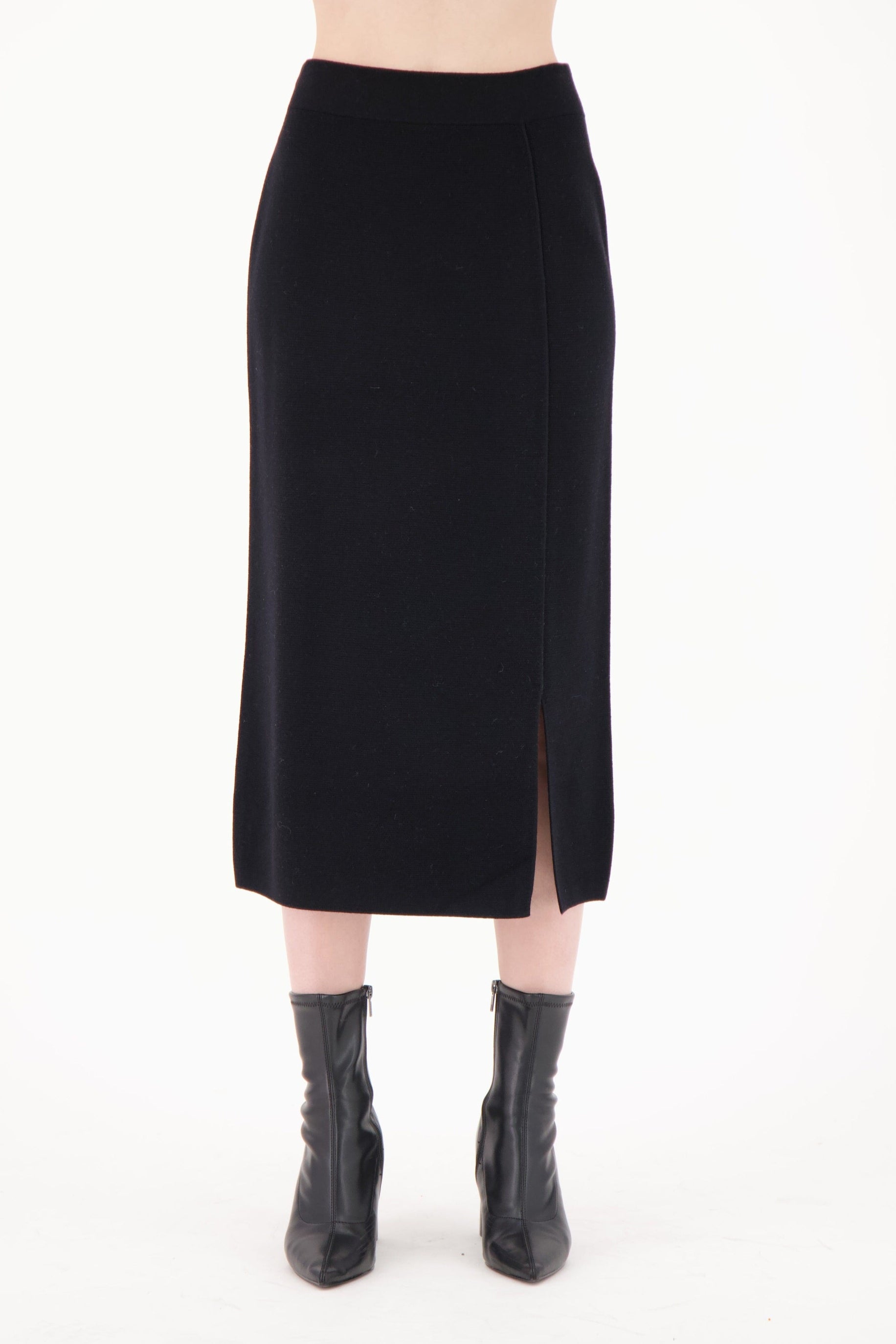 Black pencil skirt worn by a person on a white background