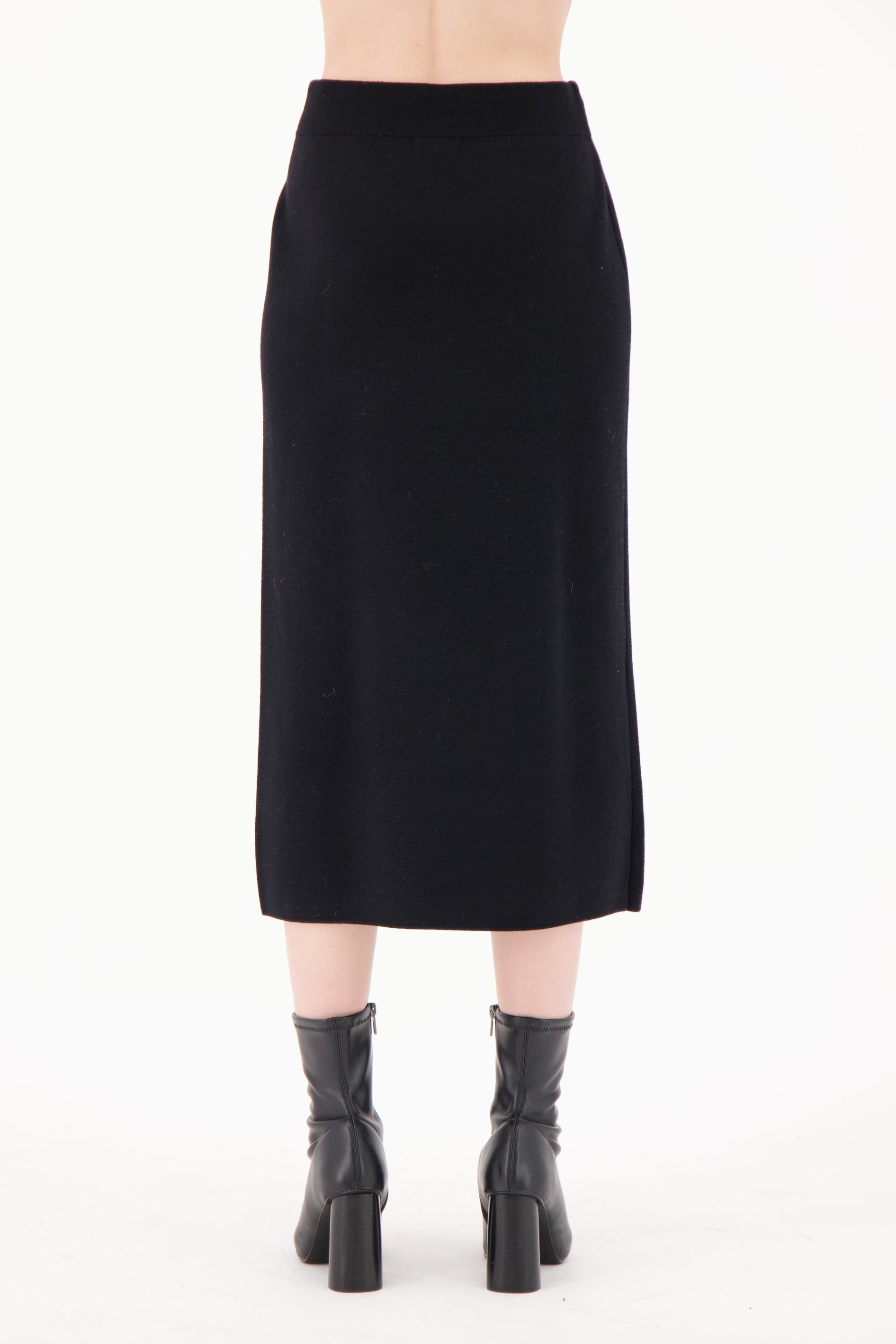 Black skirt worn by a person on a white background