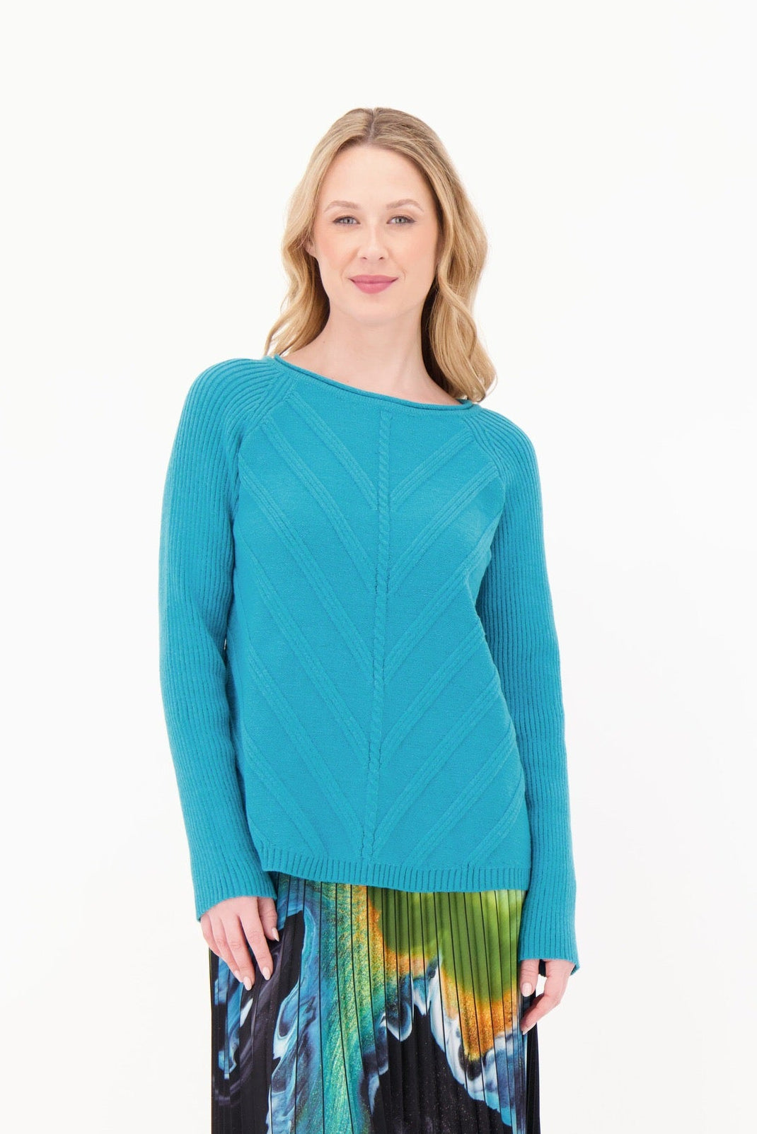 Woman wearing a teal sweater on a white background