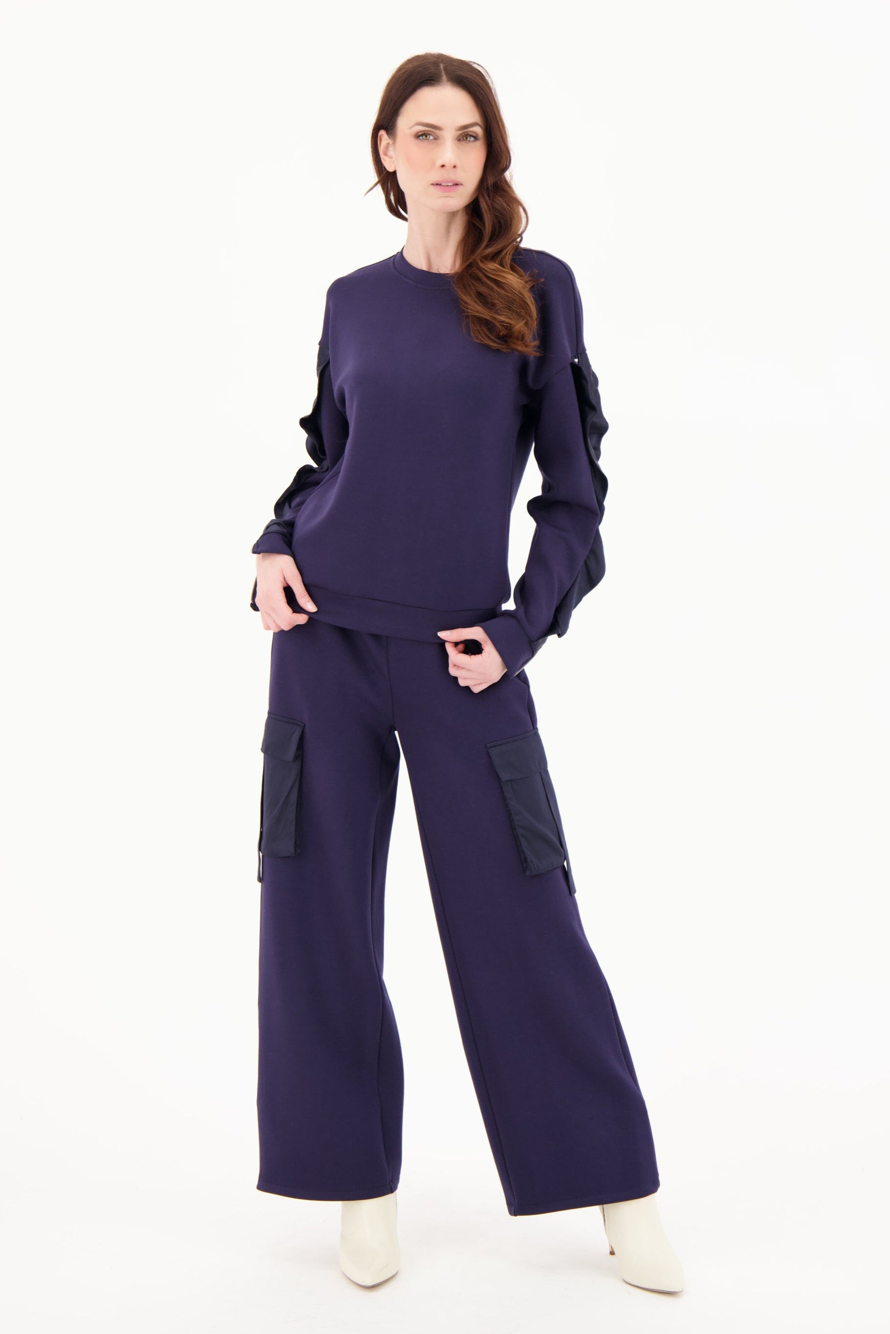 Woman wearing a purple outfit on a white background