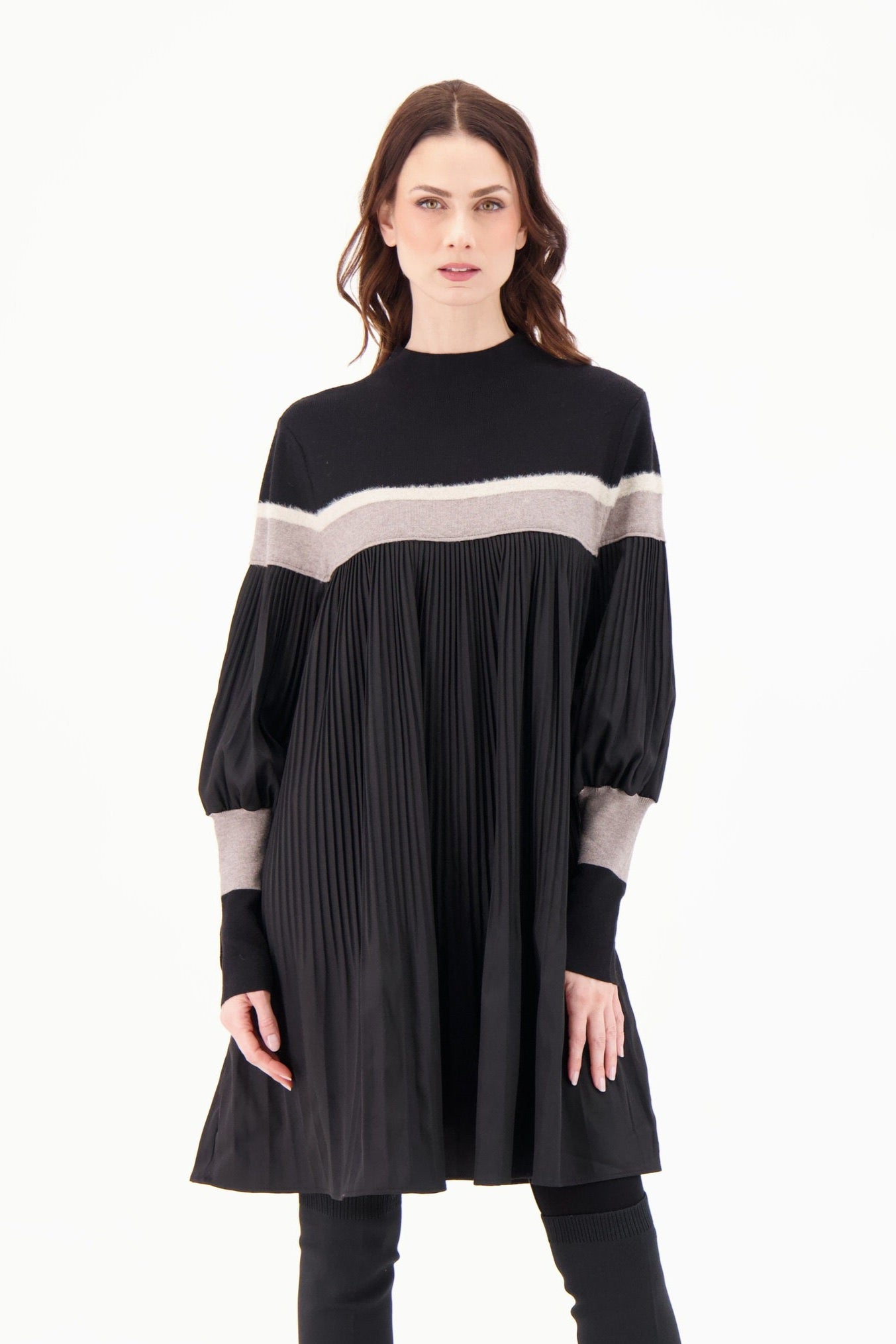 Woman wearing a black dress with gray accents on a white background