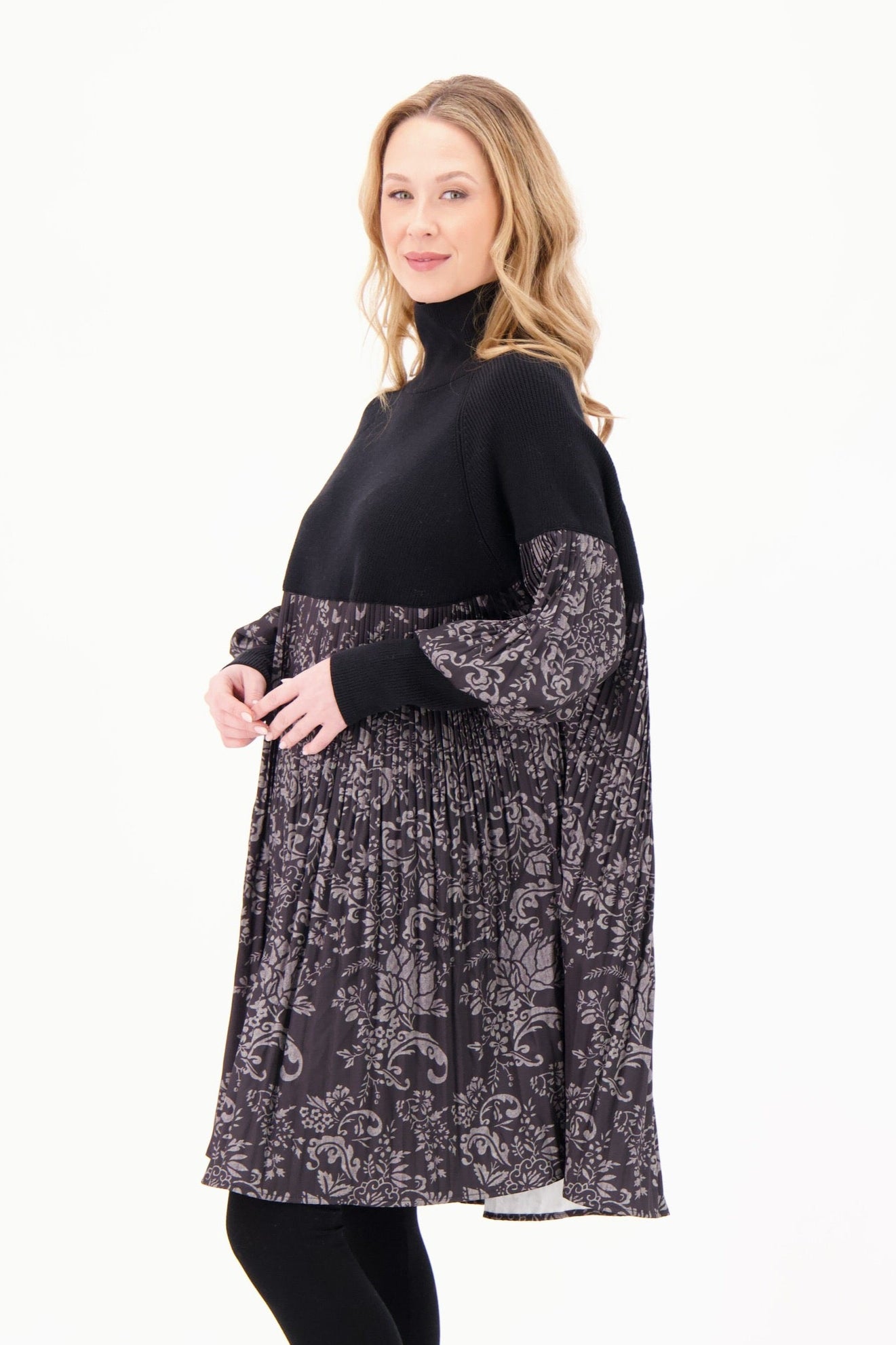 Woman wearing a black and gray patterned dress on a white background