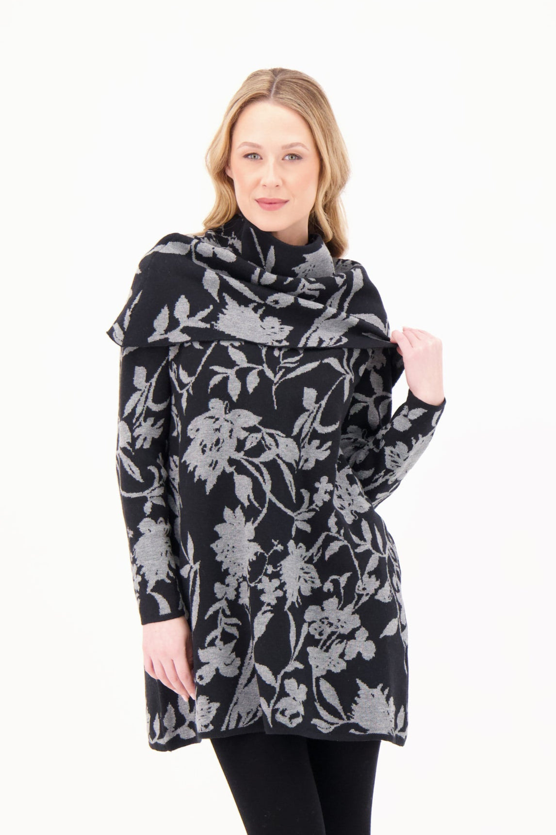Woman wearing a black floral patterned coat on a white background