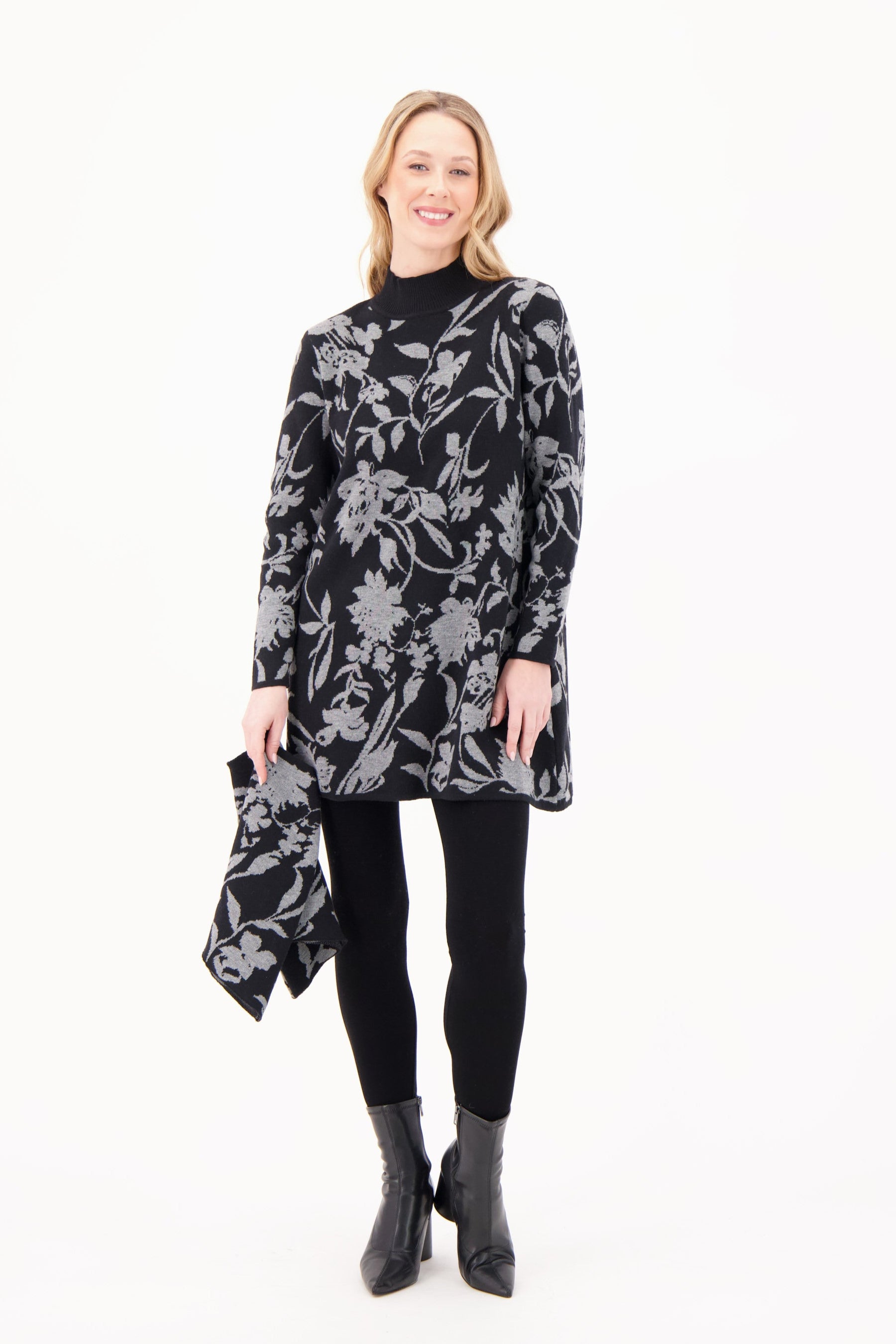 Woman wearing a black floral patterned dress on a white background