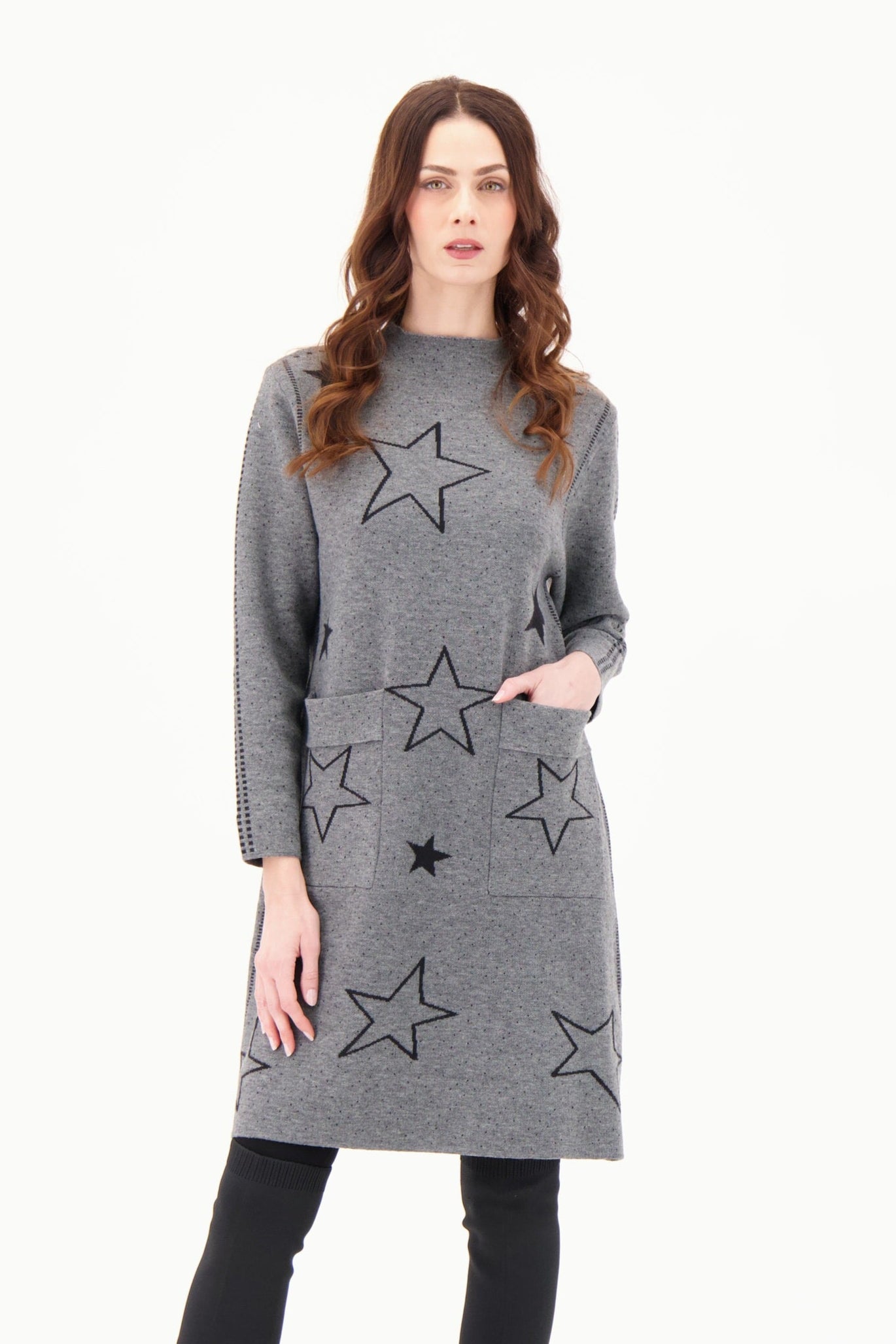 Woman wearing a gray dress with star patterns on a white background