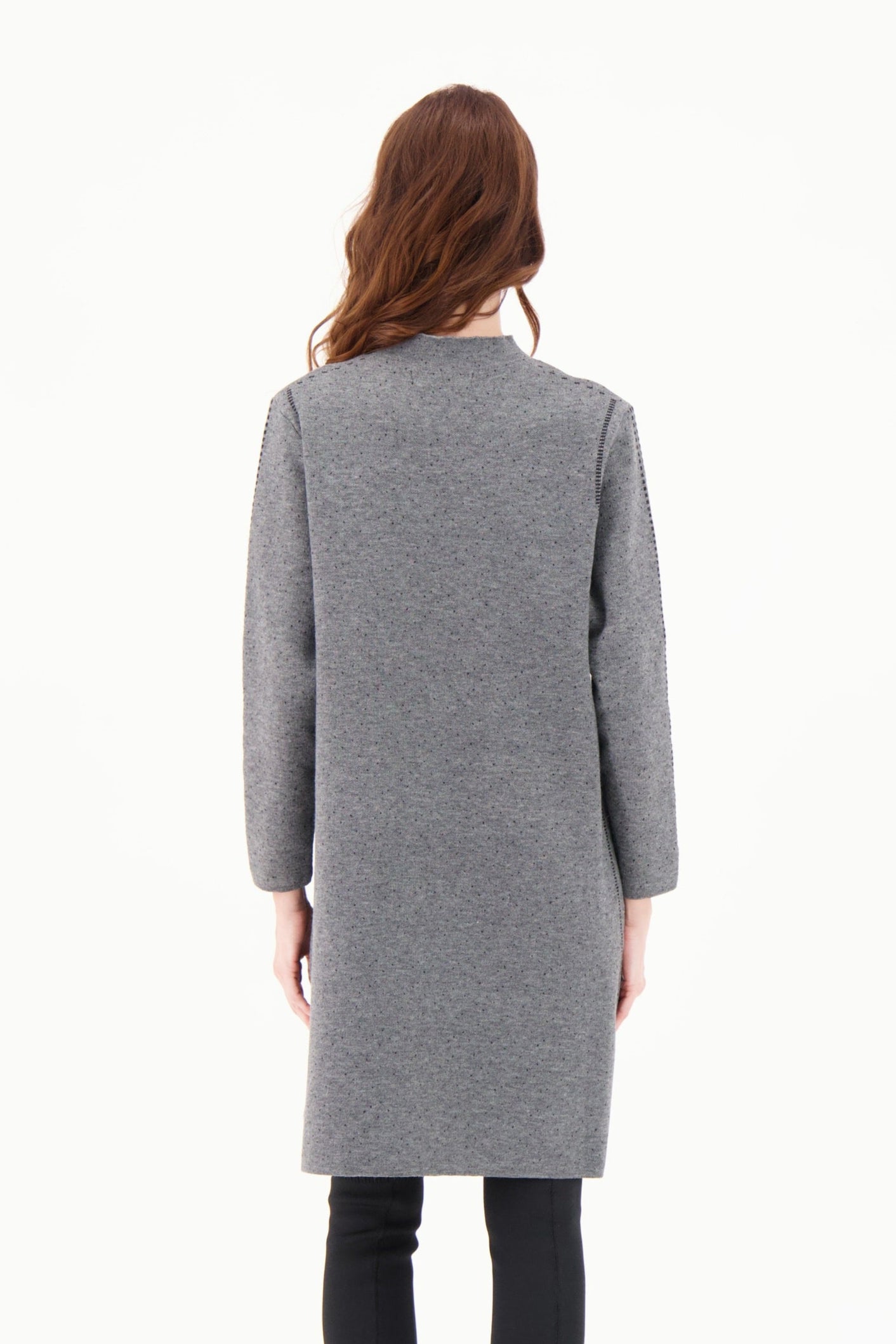 Woman wearing a gray dress on a white background