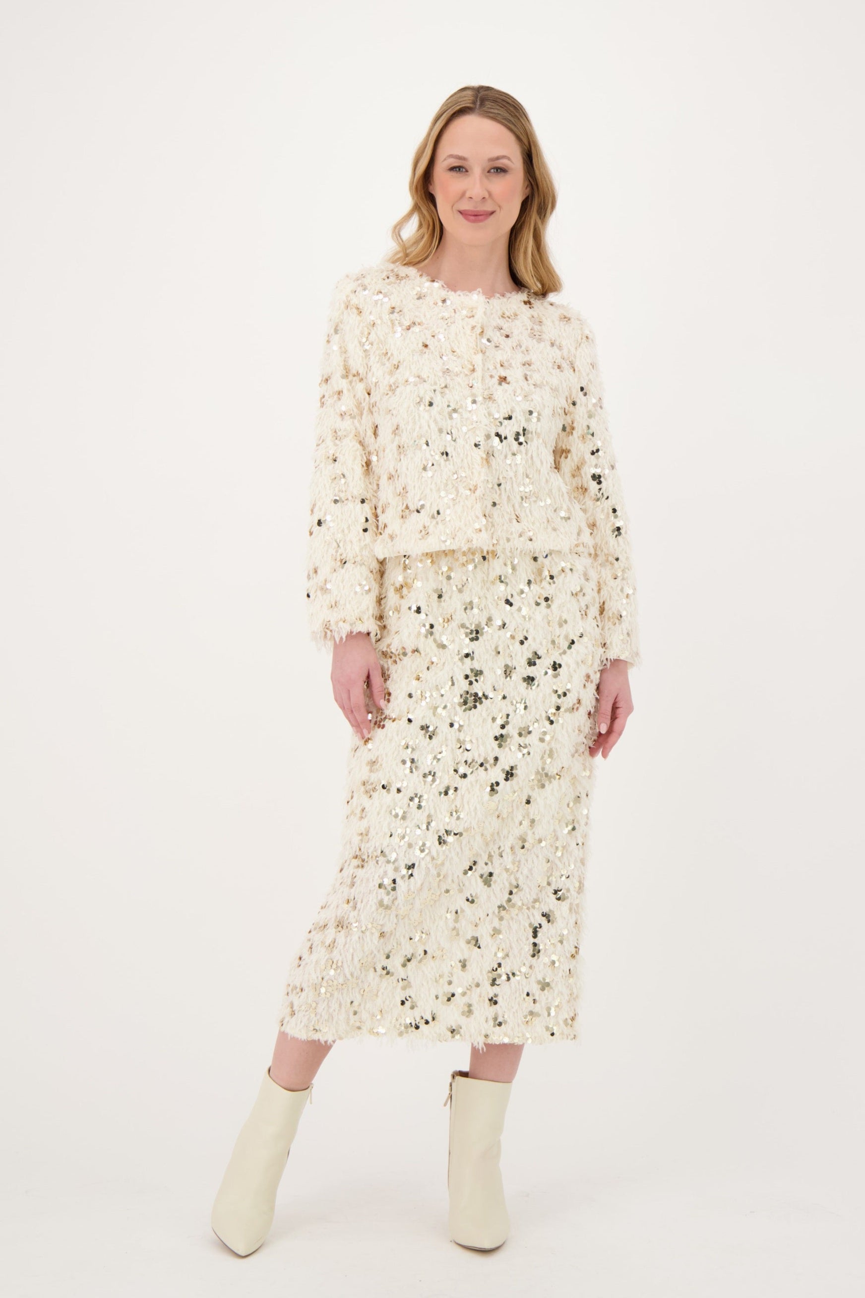 Woman wearing a floral dress and boots on a white background