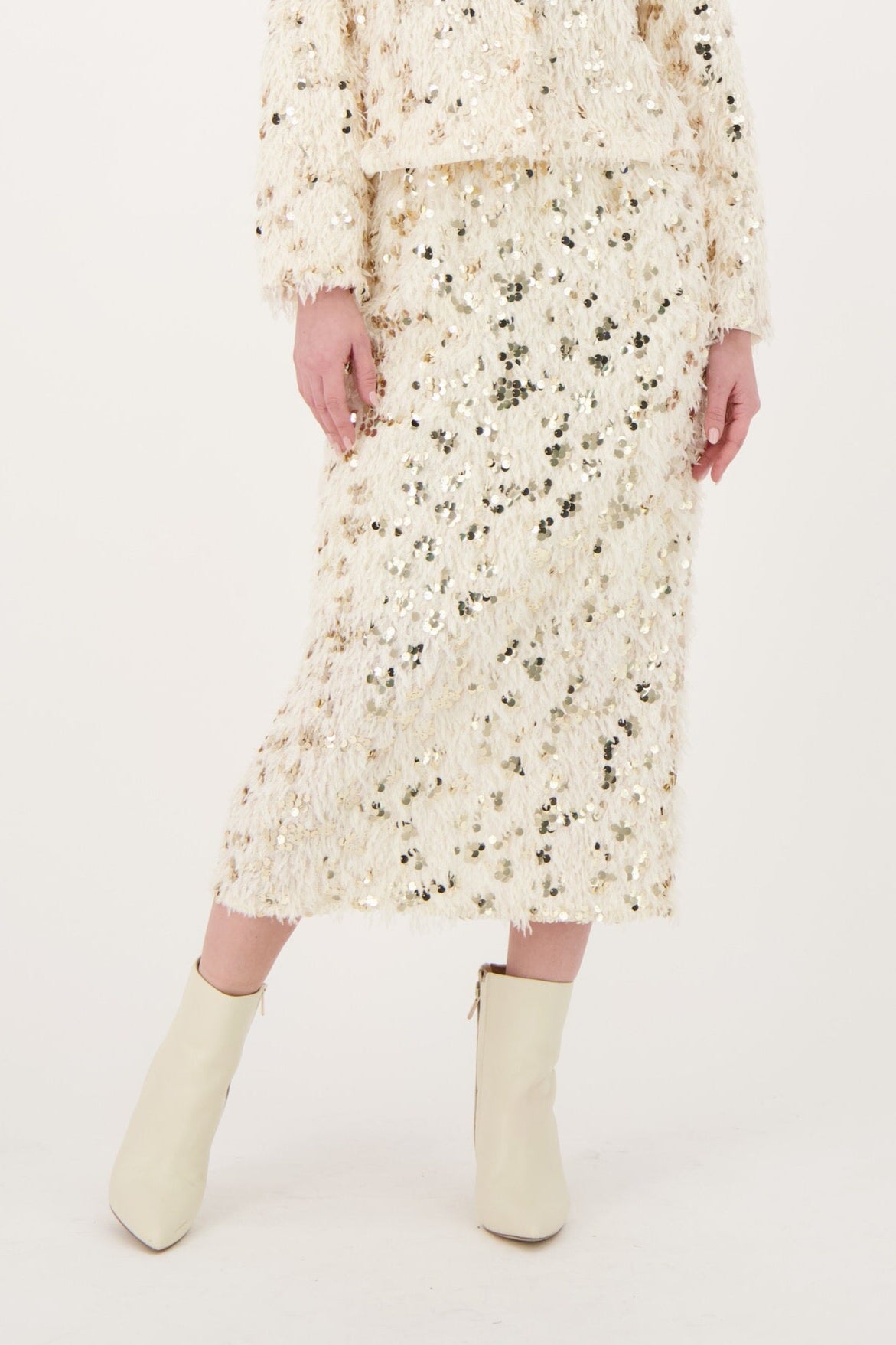 Woman wearing a floral dress and boots on a white background