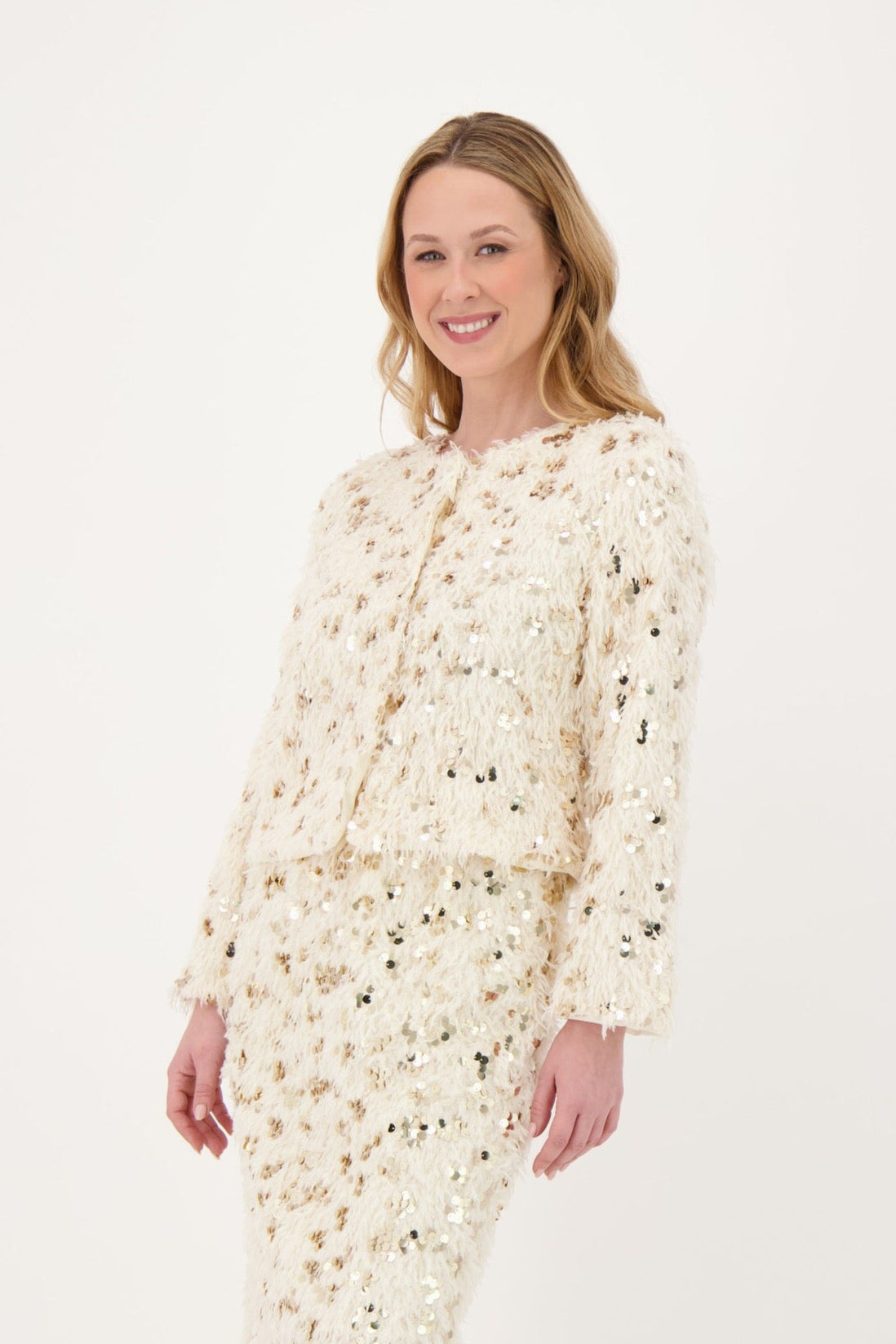 Woman wearing a floral dress and white boots on a white background