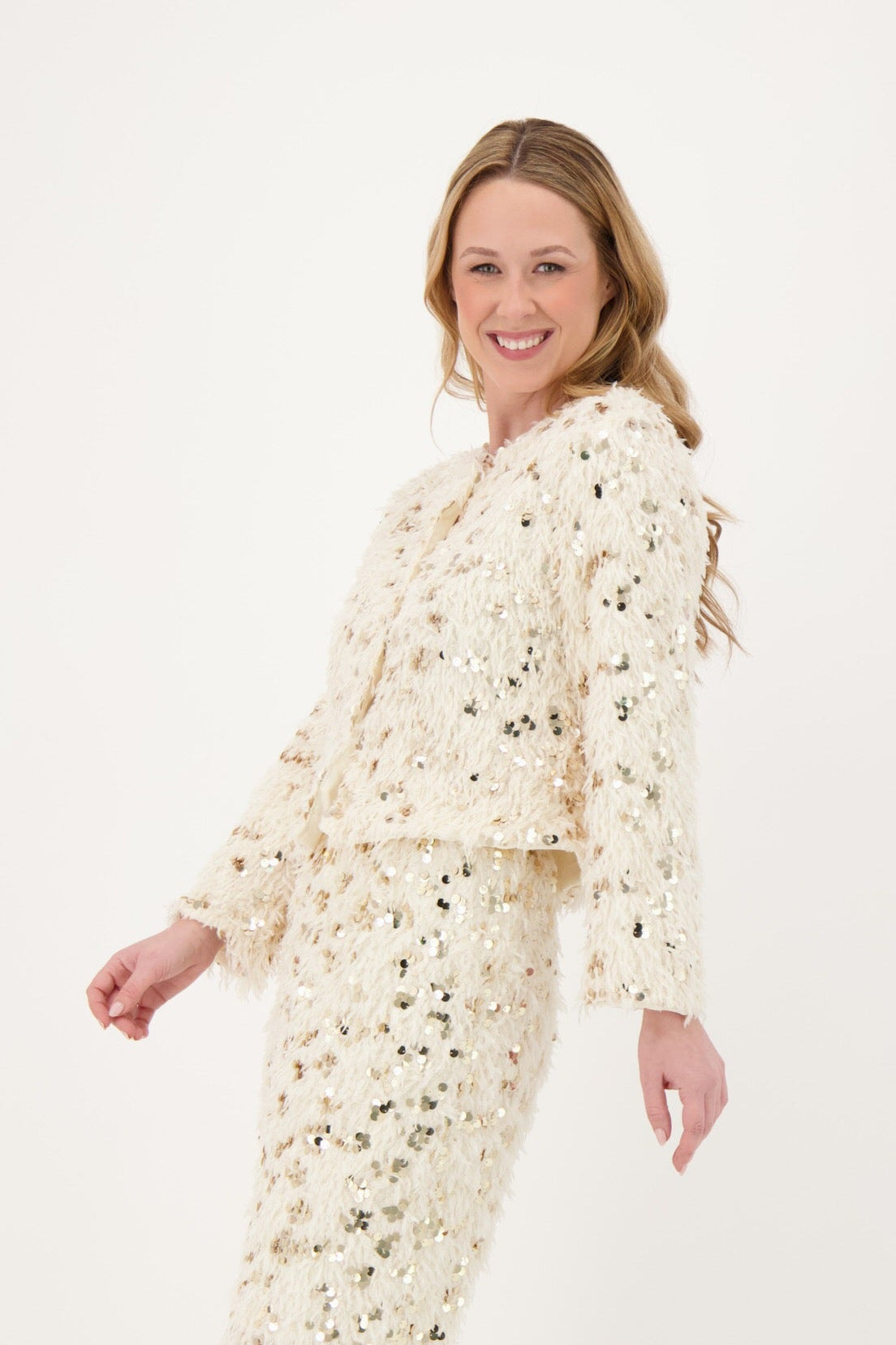 Woman wearing a floral dress and white boots on a white background