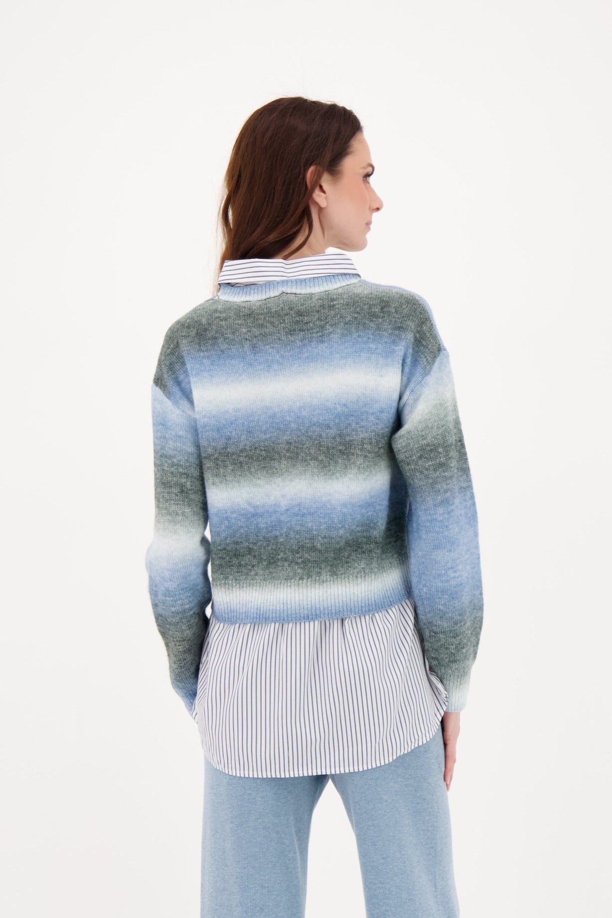 Woman wearing a striped sweater with a white background