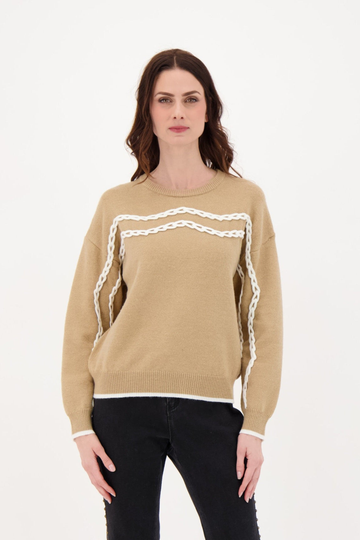 Woman wearing a beige sweater with white trim on a white background