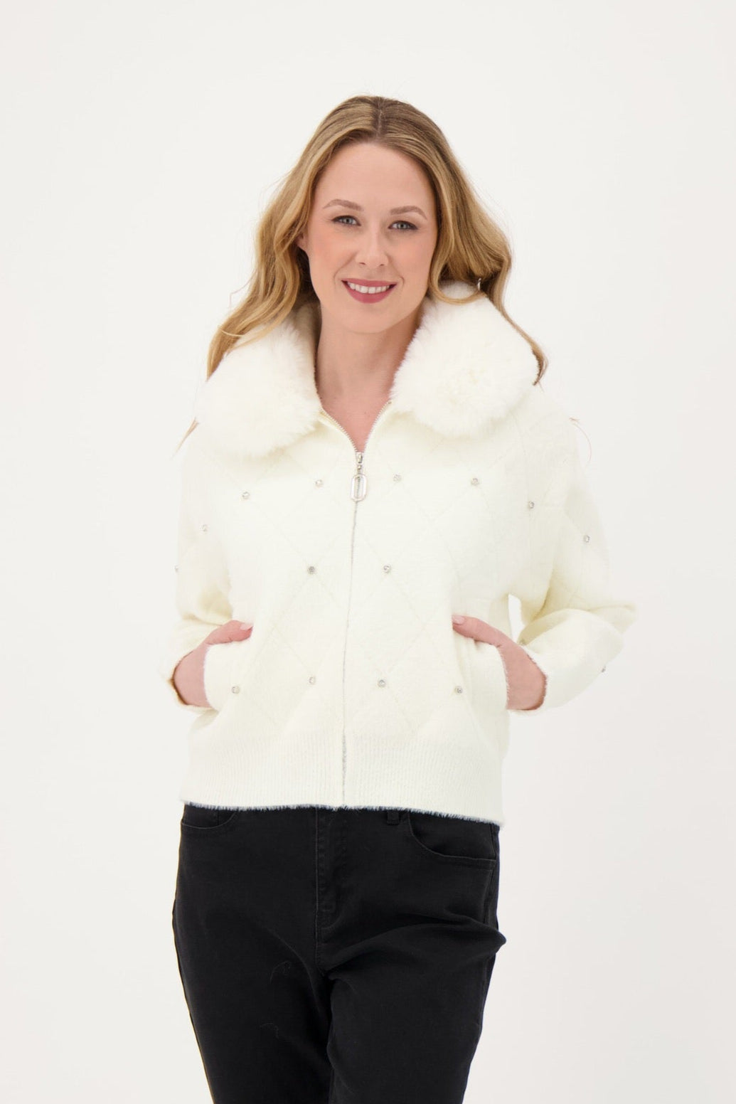 Woman wearing a white fur-lined jacket against a white background
