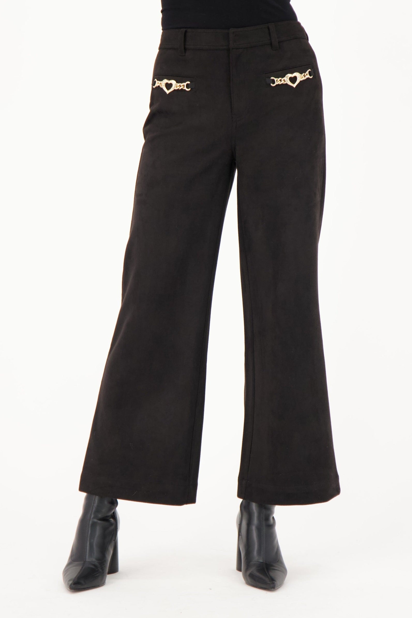 Black high-waisted pants with gold embellishments worn by a person on a white background