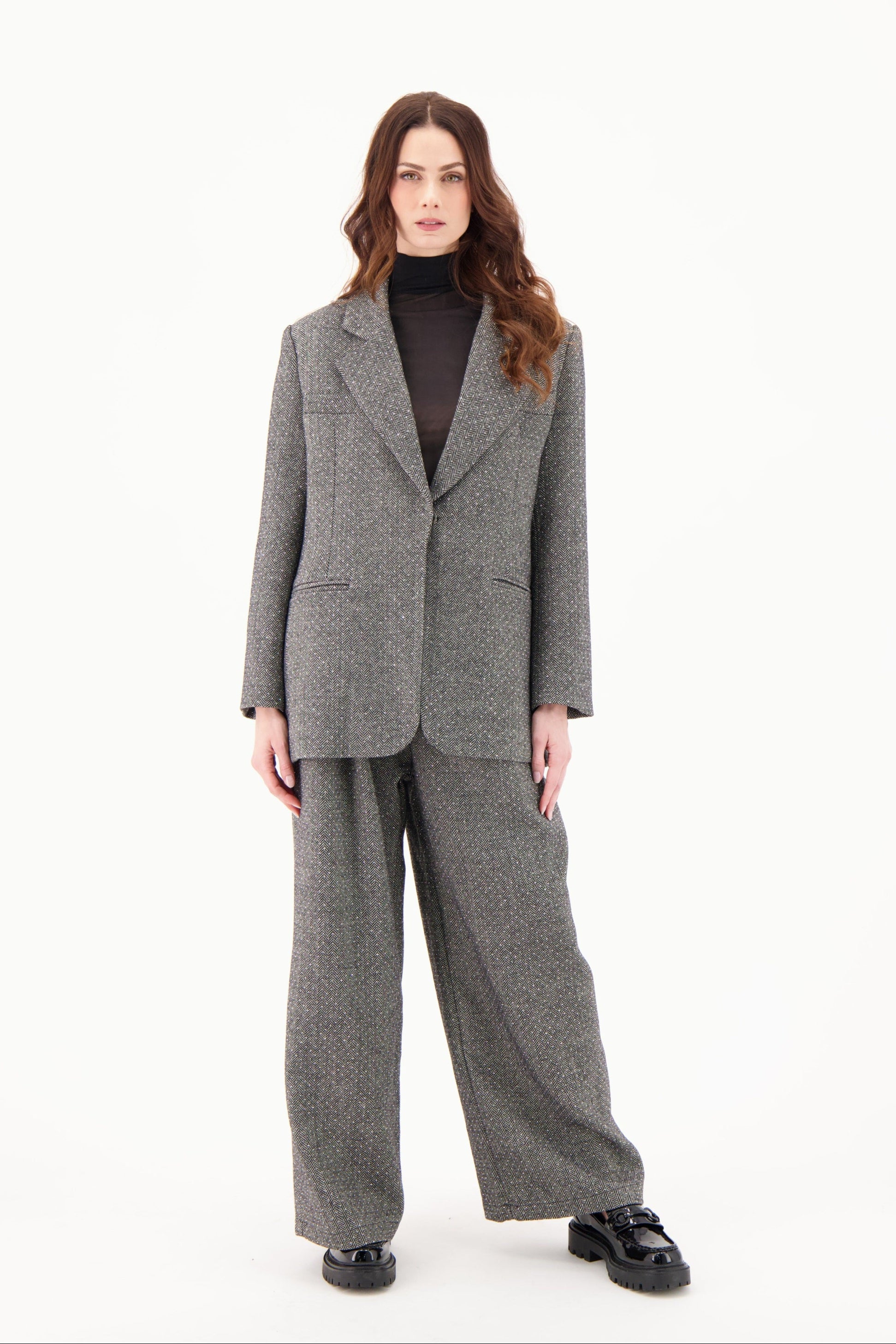 Woman wearing a gray suit on a white background