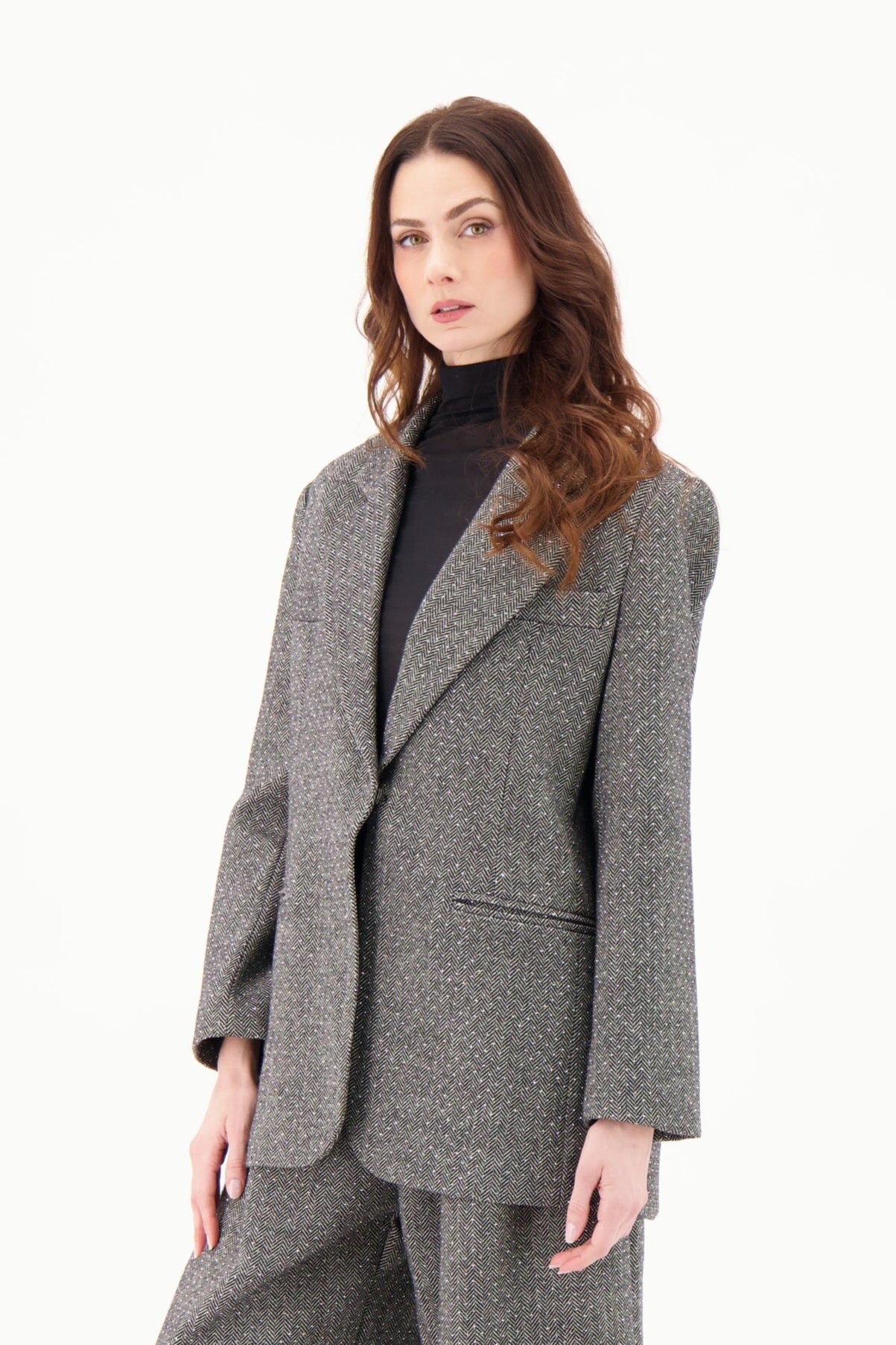 Woman wearing a gray suit on a white background