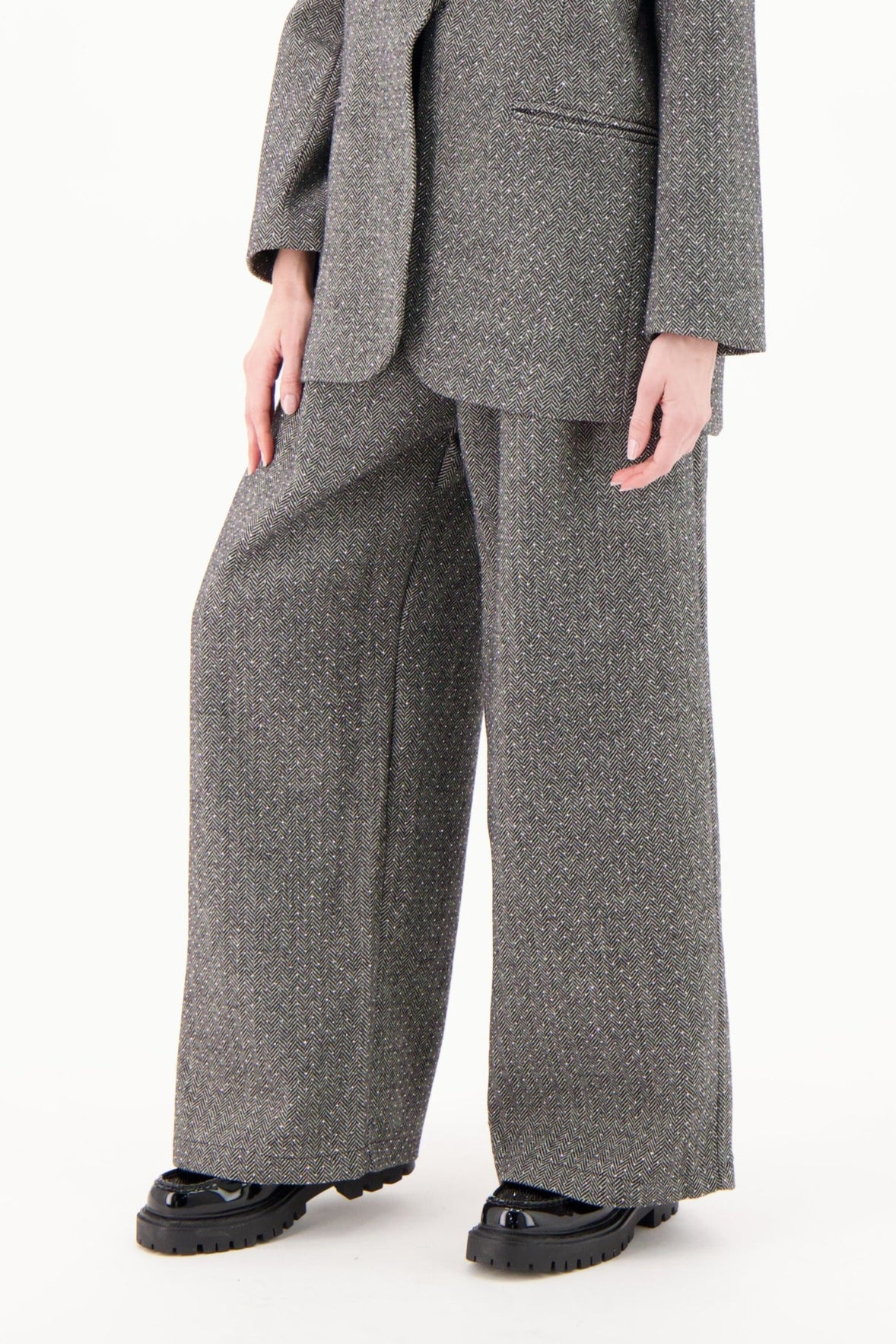 Woman wearing a gray suit on a white background