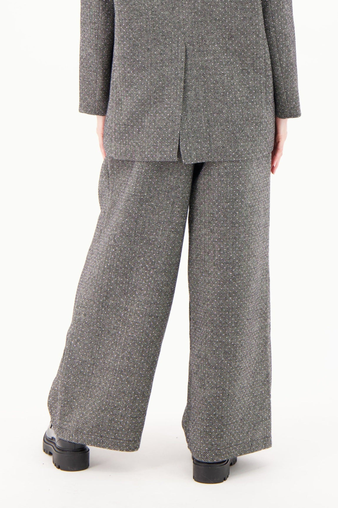 Person wearing a gray suit on a white background