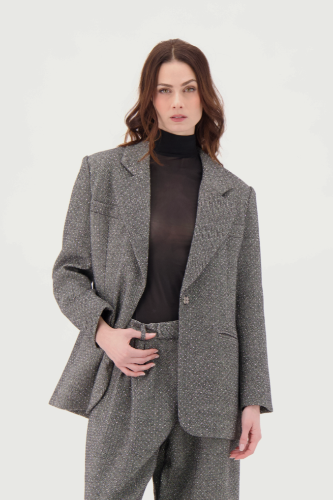 Woman wearing a gray suit on a white background