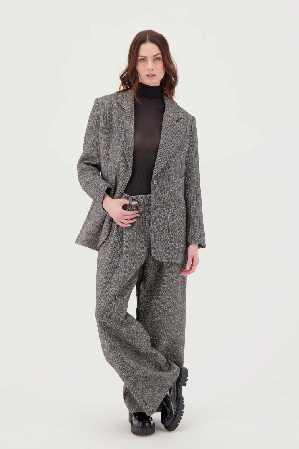 Woman wearing a gray suit on a white background
