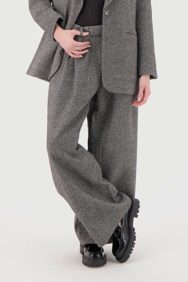 Woman wearing a gray suit on a white background